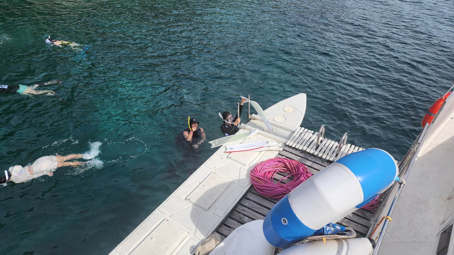Freedivers entering the water beside the training boat